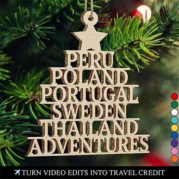 A wooden Christmas ornament shaped like a star hanging on a pine tree, inscribed with the travel destinations Peru, Poland, Portugal, Sweden, Thailand, and Adventures. The image ties the Video Editing Christmas Club offer to travel rewards.